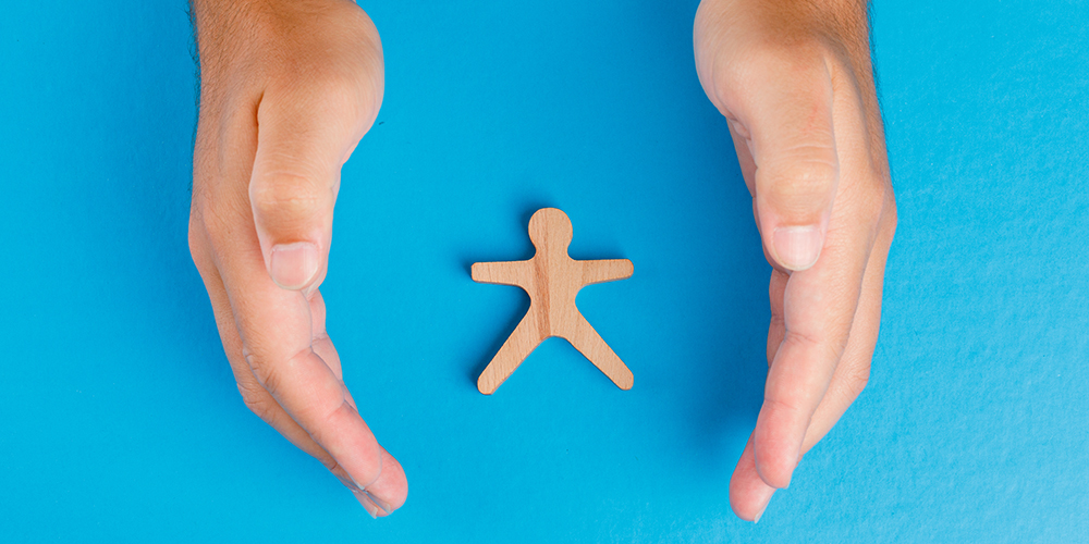 Social protection concept on blue background flat lay. hands tak