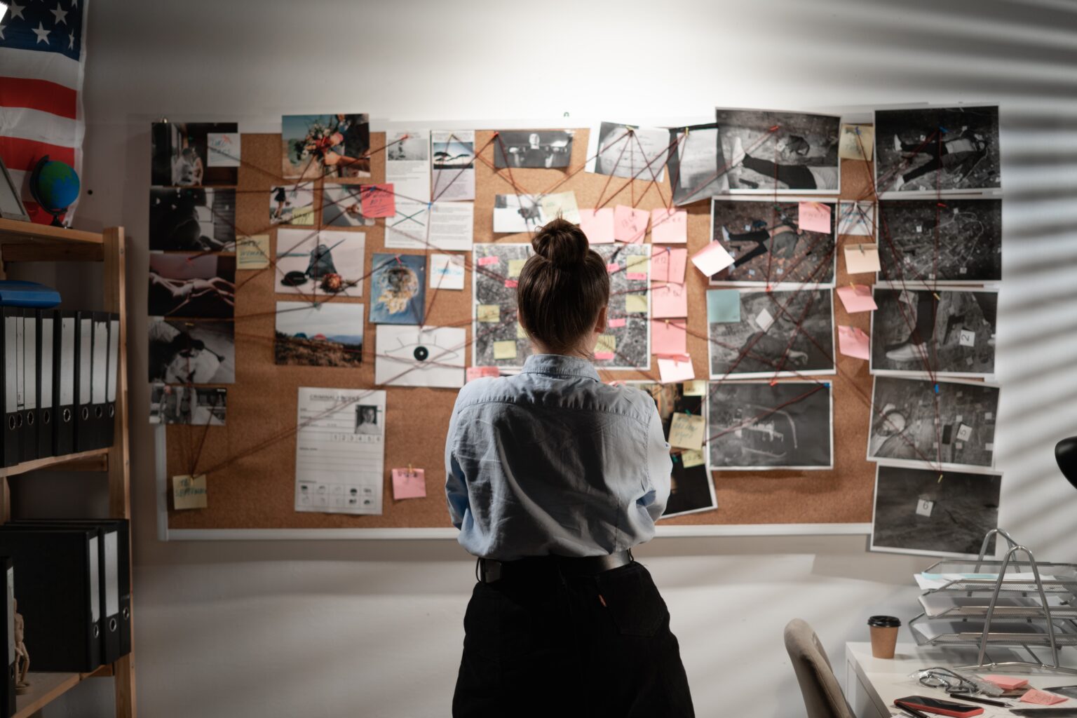 Young,Female,Detective,Looking,At,Evidence,Board,,Back,View.,Copy