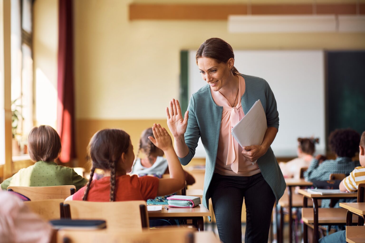 Happy,Elementary,School,Teacher,Giving,High-five,To,Her,Student,During